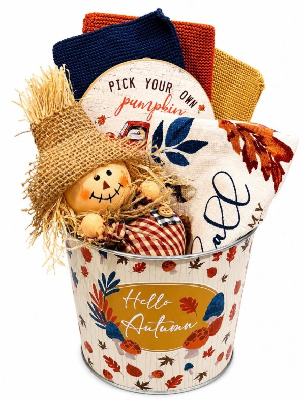 Fall kitchen decor gift basket featuring dishtowels and autumn home accents in a festive tin