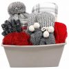 Womens warm and cozy apparel blanket and candle gift set featuring winter wearables and throw